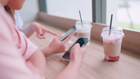 Close-up of happy couple using smartphone to view funny photos and videos.  Stock Footage 265231115