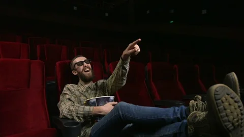 Close up, happy face of a man enjoying a movie at the movie theatre. Stock Footage 88133529