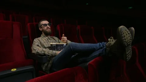 Close up, happy face of a man enjoying a movie at the movie theatre. Stock Footage 88134856