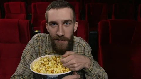 Close up, happy face of a man enjoying a movie at the movie theatre. Stock Footage 88135172