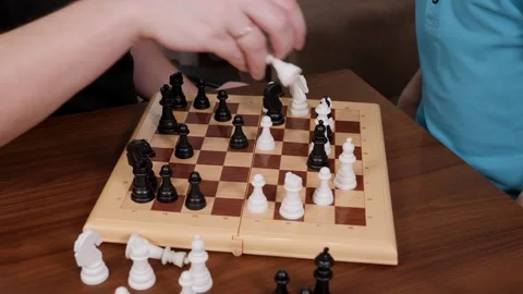 Close-up of a happy father playing chess with his little son at home. Stock Footage 305293368