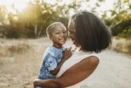 Close Up Of Happy Grandmother Holding Smiling Granddaughter Outside Stock Photos