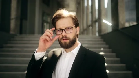 Close up of happy handsome bearded man in formal suit looking to camera and Stock Footage 190483433