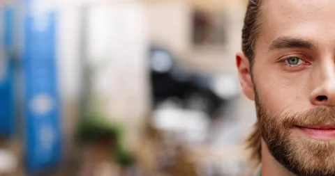 Close up of happy handsome man looking at camera while standing outdoors on Stock Footage 139307911