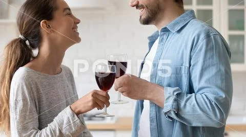 Close up happy loving couple clinking glasses of red wine Stock Photos