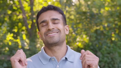 Close up happy man dancing looking at camera, eyes closed. - Slow Motion - shot Stock Footage 125164953