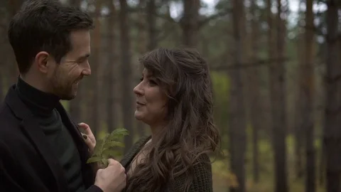 Close up of happy married couple having a date in the forest. Smiling man and Stock Footage 70485221