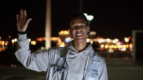 Close-up happy mixed race guy waved hand and laughing, 2x slowmotion Stock Footage 115739990