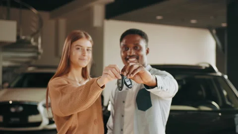 Close up of happy multicultural couple posing at modern dealership center with Stock Footage 174718832