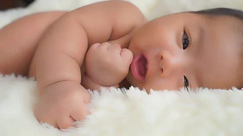 Close up of a happy one month old, Asian-American baby boy Stock Footage 75743592