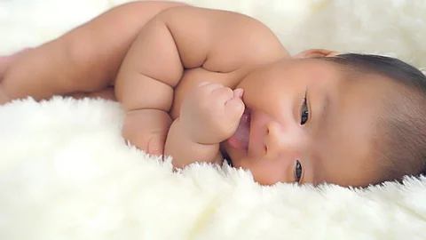 Close up of a happy one month old, Asian-American baby boy Stock Footage 75743693