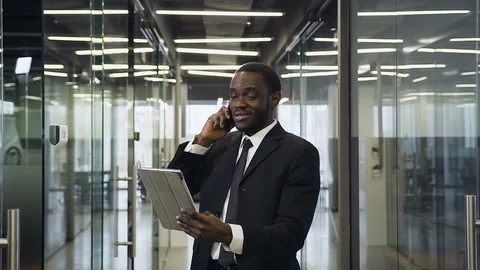 Close up of happy professional black-skinned businessman which talking on phone Stock Footage 125086880