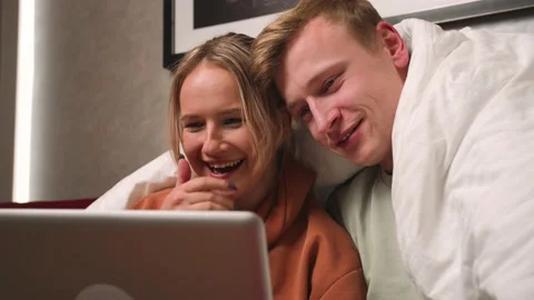 Close up Happy smiling couple using laptop at home. man and woman watching Video stock 146604073