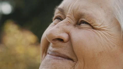Close up, happy smiling face expression of an elderly woman with wrinkles Stock Photos