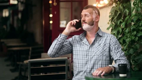Close up of happy smiling middle aged man with vitiligo on his face calling on Stock Footage 170068063