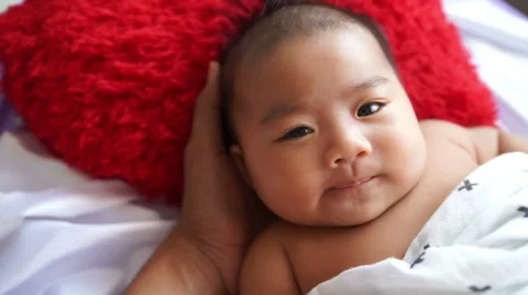 Close up of a happy three month old, Asian baby boy Stock Footage 63803414