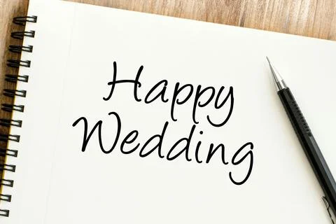 Close-up of Happy Wedding message elegantly handwritten on a spiral noteboo.. Stock Photos