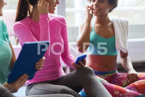 Close up of happy women listening to music in gym Stock Photos