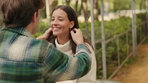 Close-up, happy young couple man and woman talking sitting in park Stock Footage 300795864