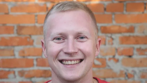 Close up of happy young man looking into camera with positive emotions Stock Footage 129884147