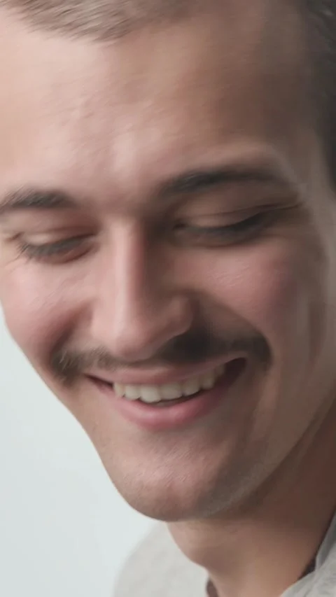 Close-up of Happy Young Man Turning and Laughing at Camera on White Backgroun Stock Footage 341659467