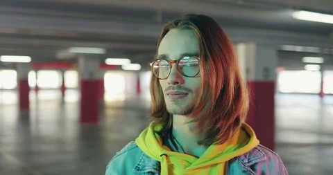 Close up of the happy young stylish man hipster with long hair and in glasses Stock Footage 100982872