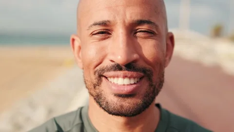 Close-up of hapy man smiling against blured background of the sea and sky Stock Footage 278047443