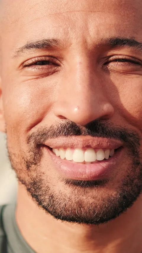 Close-up of hapy man smiling against blured background of the sea and sky Stock Footage 288715698