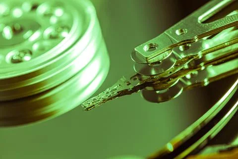 Close-up of hard disk drive reading data with green light 写真素材