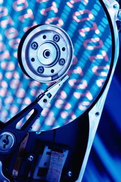 Close up of a hard drive with binary code superimposed over it 스톡 사진
