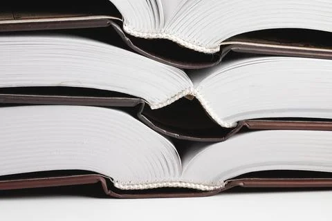 Close-up of the hardback of a thick book on a gray background. Reading and Stock Photos
