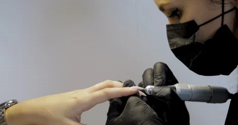 Close-up of hardware manicure with electric machine removes the nail polish. Stock Footage 115045576