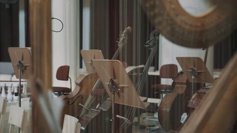 Close up harp string, music stands and cello on background focus pull Stock Footage 71927787