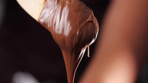 Close-up of hazelnut cream or chocolate on wooden spoon Stock Footage 142486470