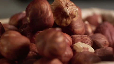 Close up of hazelnuts falling into a basket Stock Footage 152383461