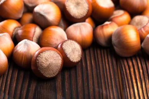 Close up of hazelnuts on wooden table - Image Stock Photos