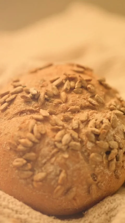 Close-up hd slow motion video of homemade bread on a rustic background. Stock Footage 133443241
