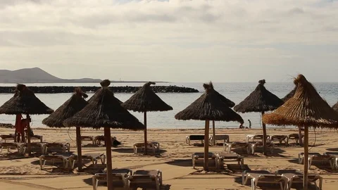 Close-Up hd video of the umbrellas in the beach in a cloudy day. Stock Footage 99654970