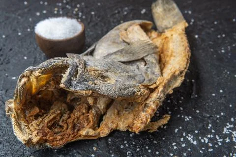 Close-up of the head of a dried cod preserved with salt on a black background Stock Photos
