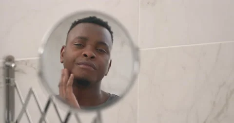 Close up head shot mirror reflection of African man checking out his shaving and Stock Footage 153286720