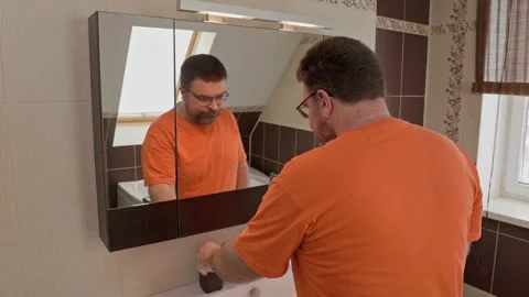 Close up head shot mirror reflection man brushing teeth with toothpaste. Stock Footage 167258135