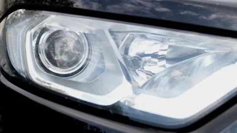 Close-up, headlight of a car turns on high beam intermittently Stock Footage 131519716
