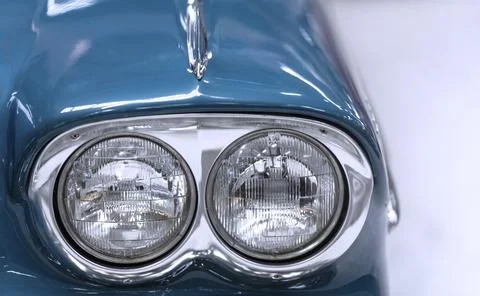 Close up with the headlight from an old timer blue car 스톡 사진