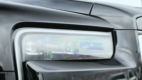 Close-up of a headlight with the Rolls Royce logo Stock Footage 320153637