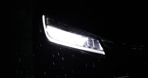 Close-up headlight vehicle car open in rainy night street road Stock Footage 86778081