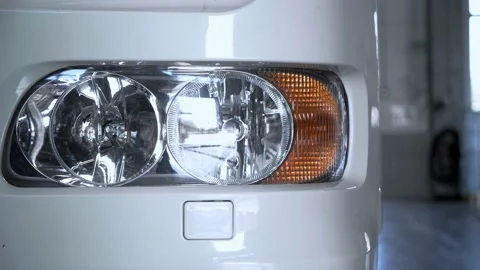 Close up Headlights of White lorry parked in a truck service station Stock Footage 152341612