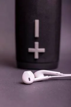 Close-up headphone stack on black background, modern speaker earbuds device a Stock Photos