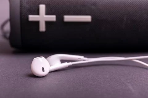 Close-up headphone stack on black background, modern speaker earbuds device a Stock Photos