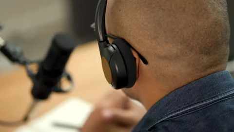 Close-up headphones of content creator man host streaming his a podcast. Stock Footage 186389600
