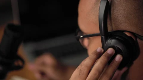 Close-up headphones of content creator man host streaming his a podcast. Stock Footage 186486710